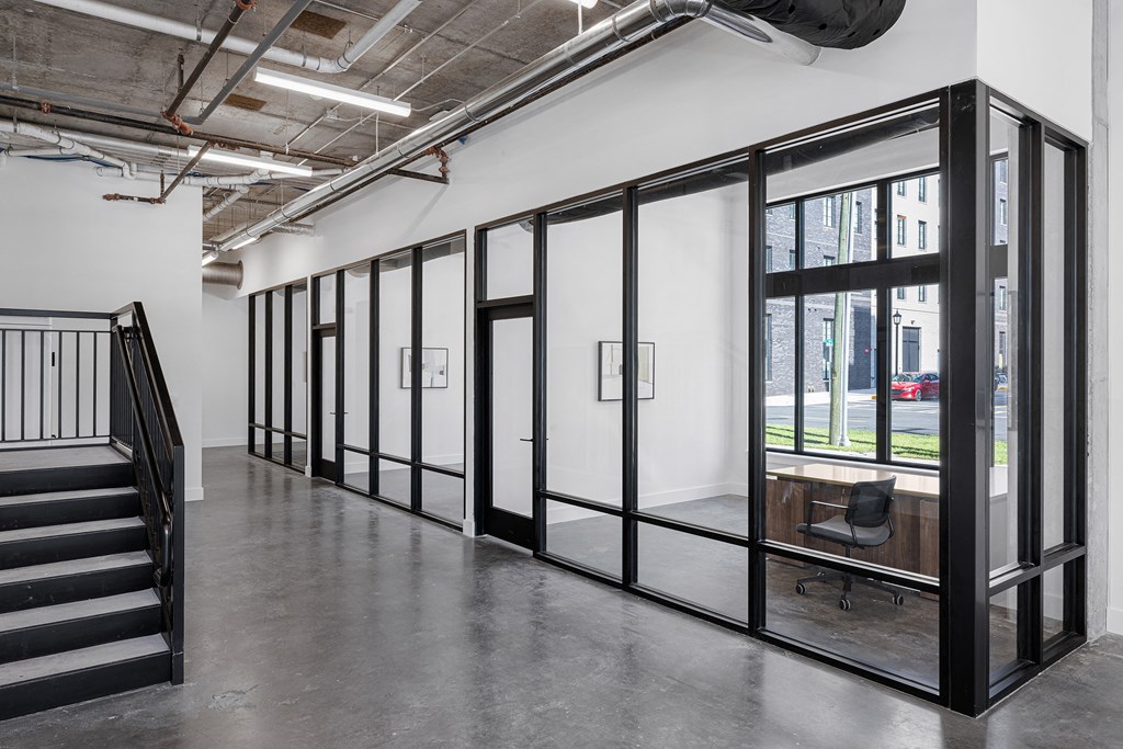 a conference room with glass doors and a staircase