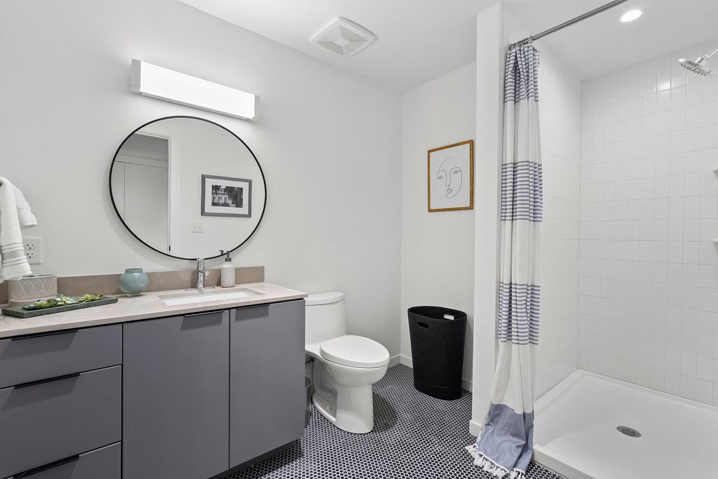 a bathroom with a white toilet next to a bathtub with a shower curtain