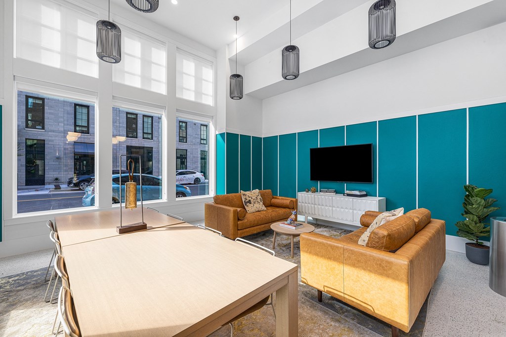 a living room with couches a table and a television