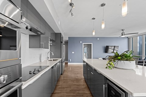 an open kitchen with a large island and a living room