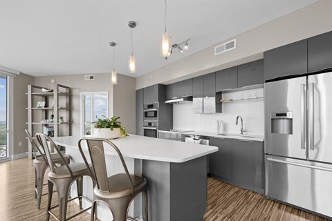 a kitchen with stainless steel appliances and a white counter top