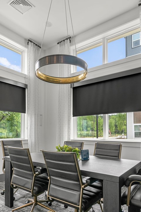 A modern dining room with a large table and chairs.