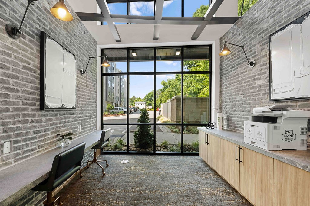 A room with a brick wall and a glass door leading outside.