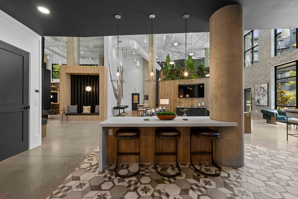 A modern kitchen with a bar stool and a counter.