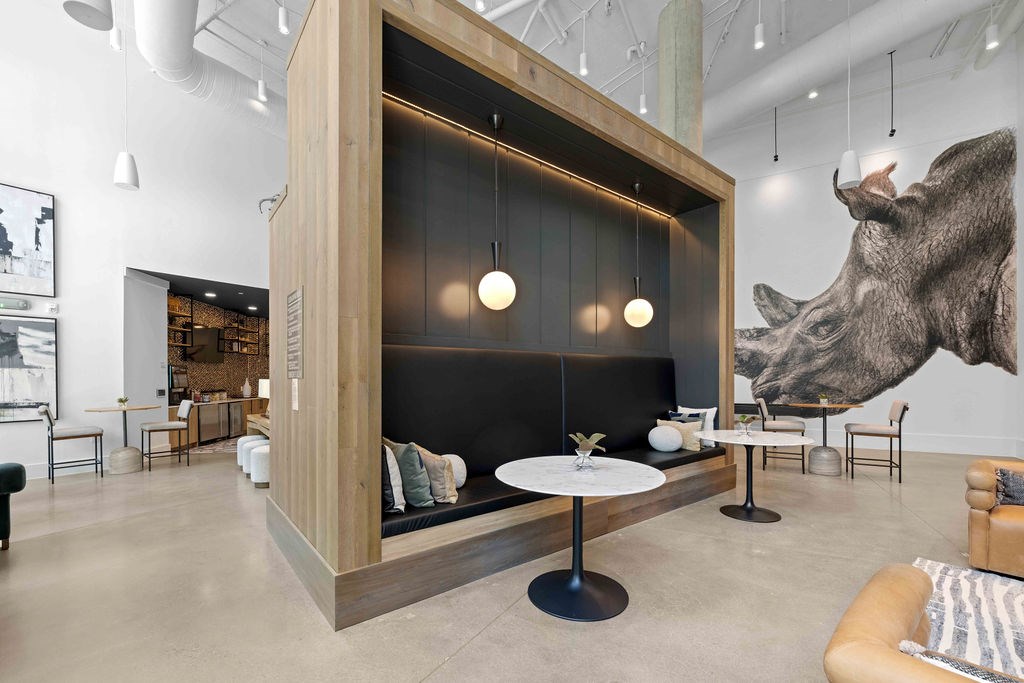 A modern living room with a large wolf head on the wall.