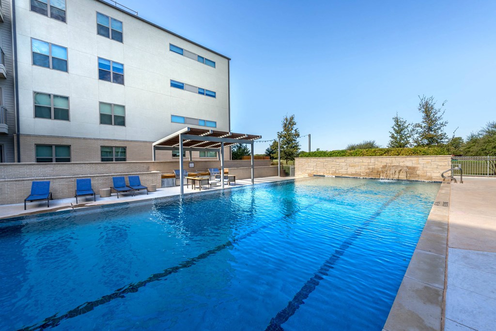a swimming pool with a building in the background