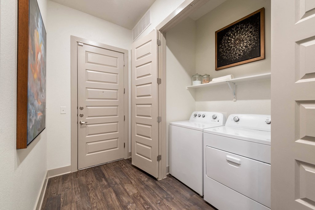 a laundry room with a washer and dryer and a closet