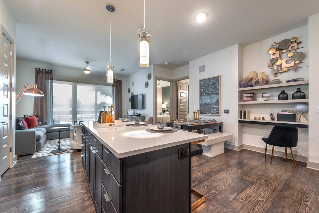a kitchen with a large island and a living room