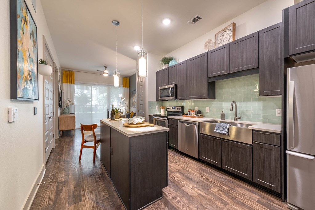 a kitchen with stainless steel appliances and a counter top
