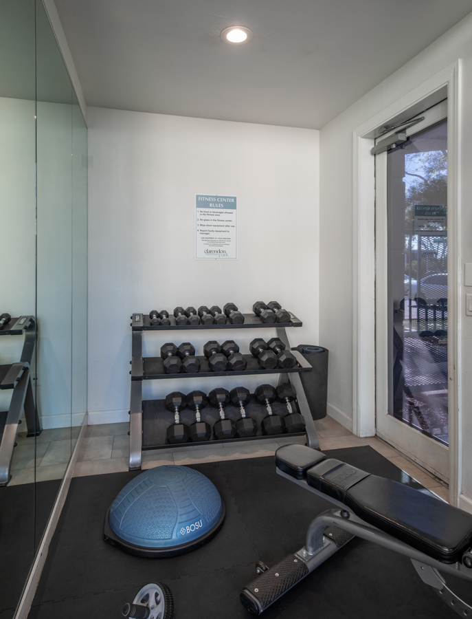 a gym with weights and a mat