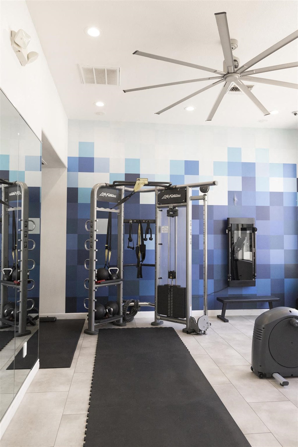 a home gym with blue and white tiles