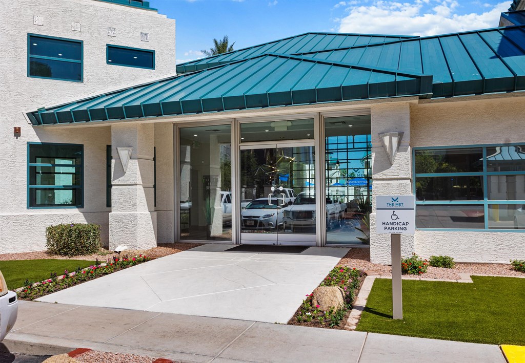 a building with a large glass door and a green metal roof