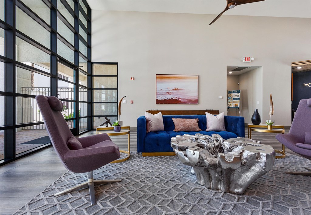a living room filled with furniture and a large window