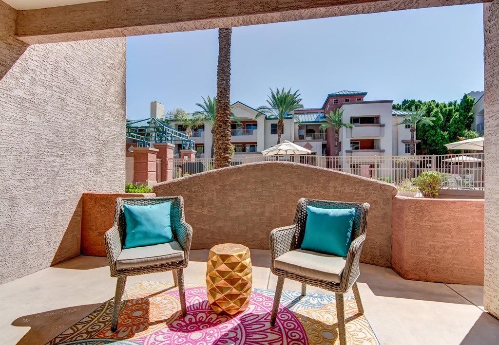 a patio with two chairs and a table