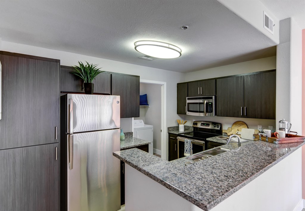 a kitchen with granite countertops and stainless steel appliances
