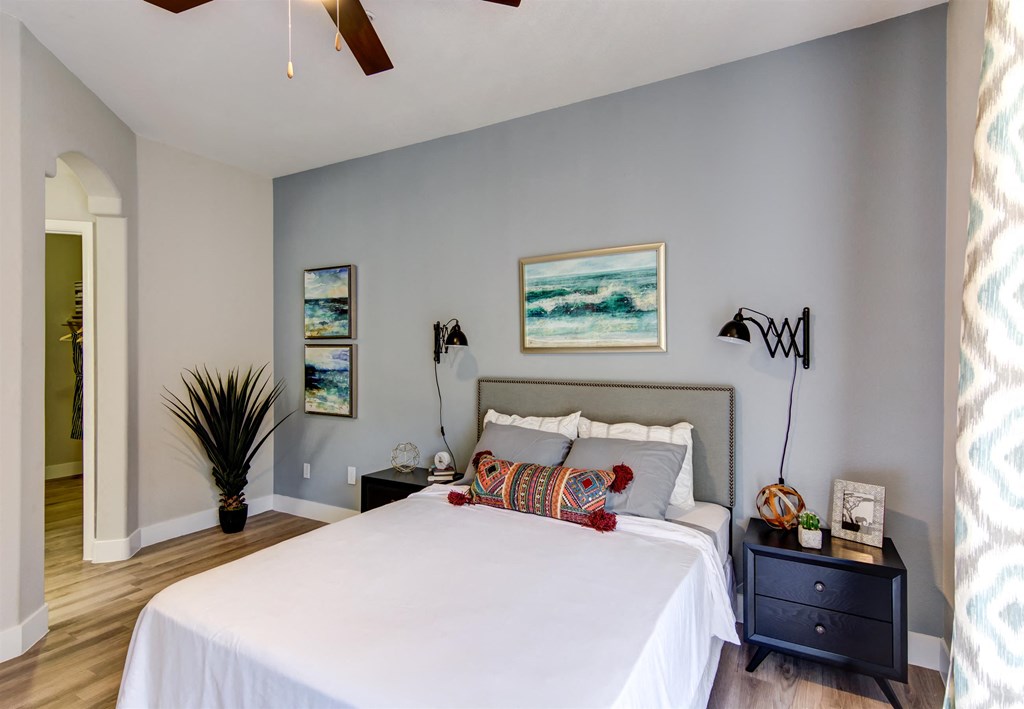 a bedroom with a bed and two nightstands