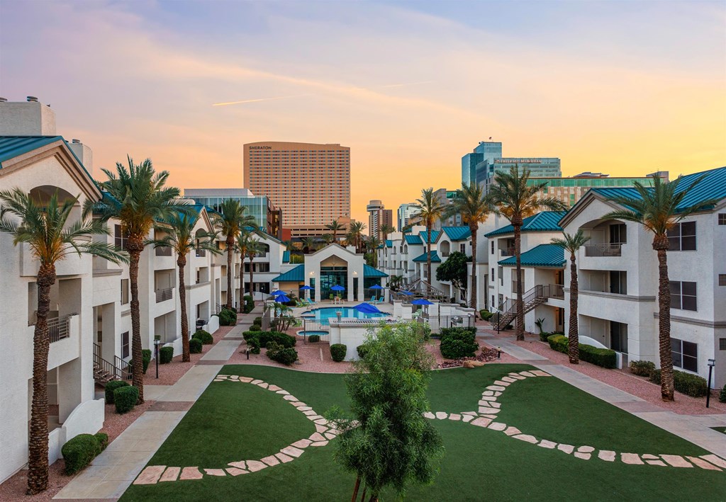 a courtyard with a pool and palm trees