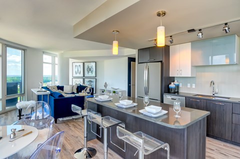 A modern kitchen with a dining table and chairs.