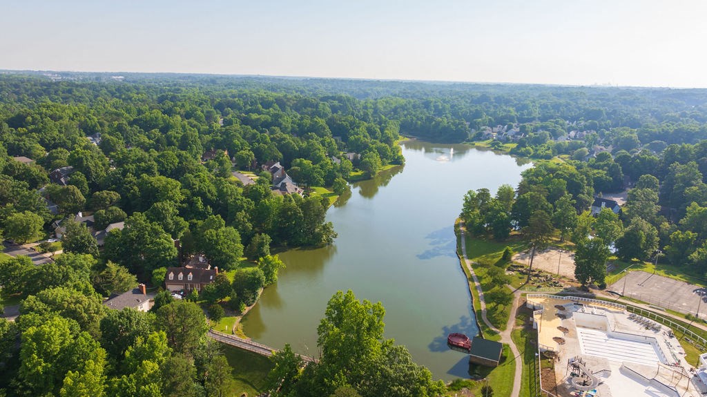 an aerial view of a body of water surrounded by trees