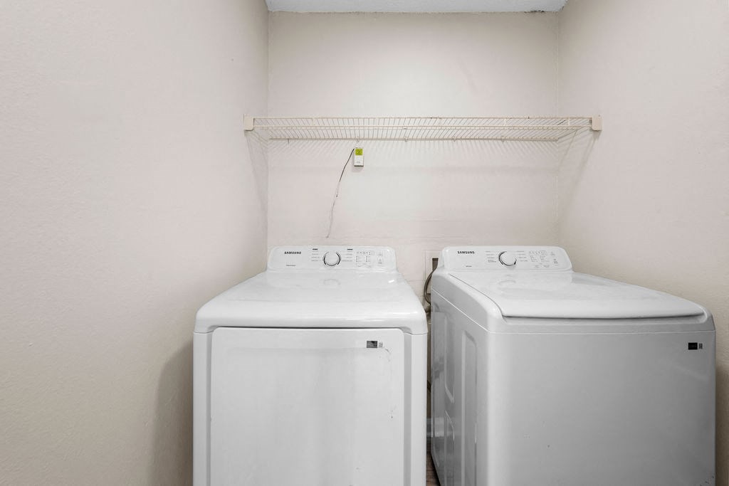 a laundry room with two washes and a dryer