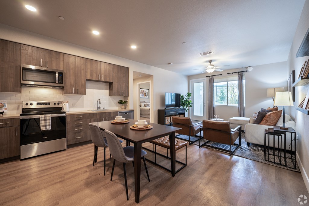 an open kitchen and living room with a table and chairs