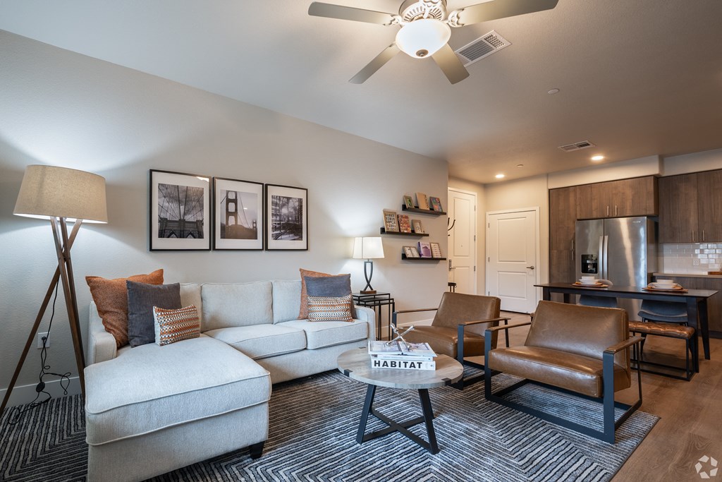 a living room with a couch and chairs and a coffee table