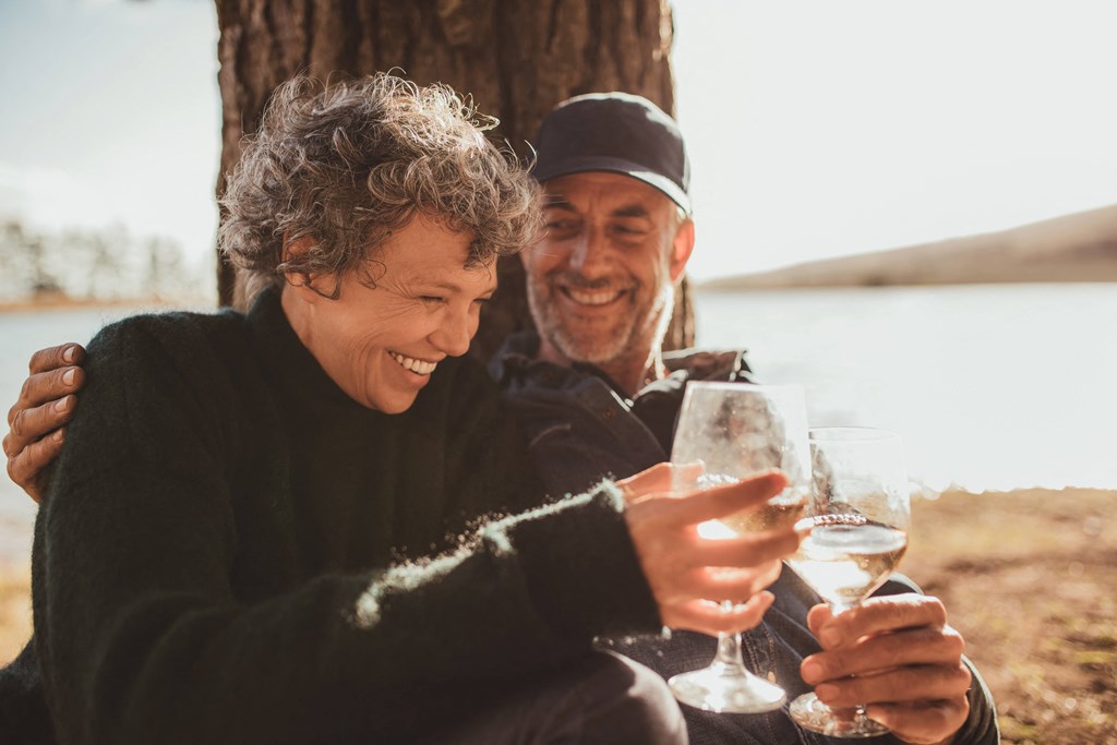 a man and a woman enjoying a beverage outdoors