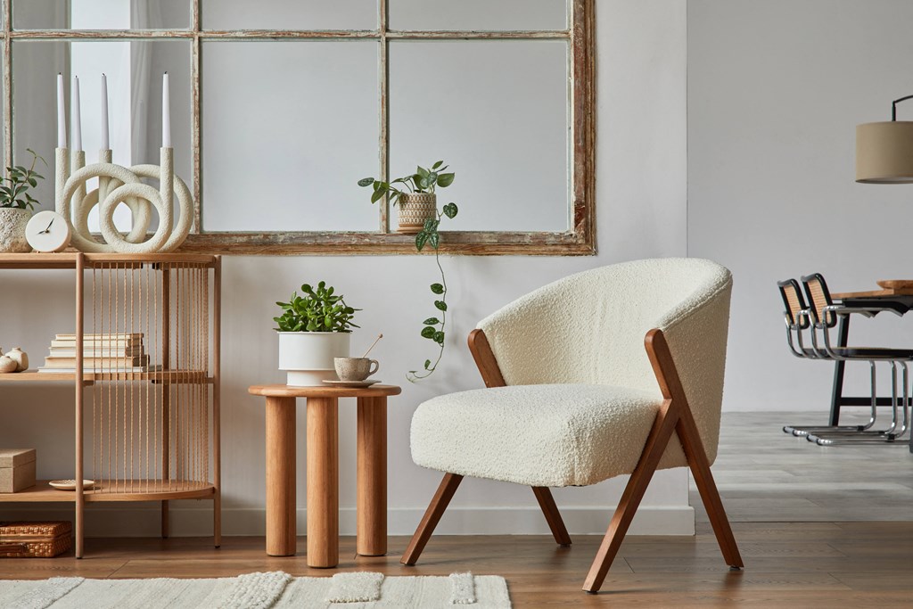 a living room with a white chair and a wooden table