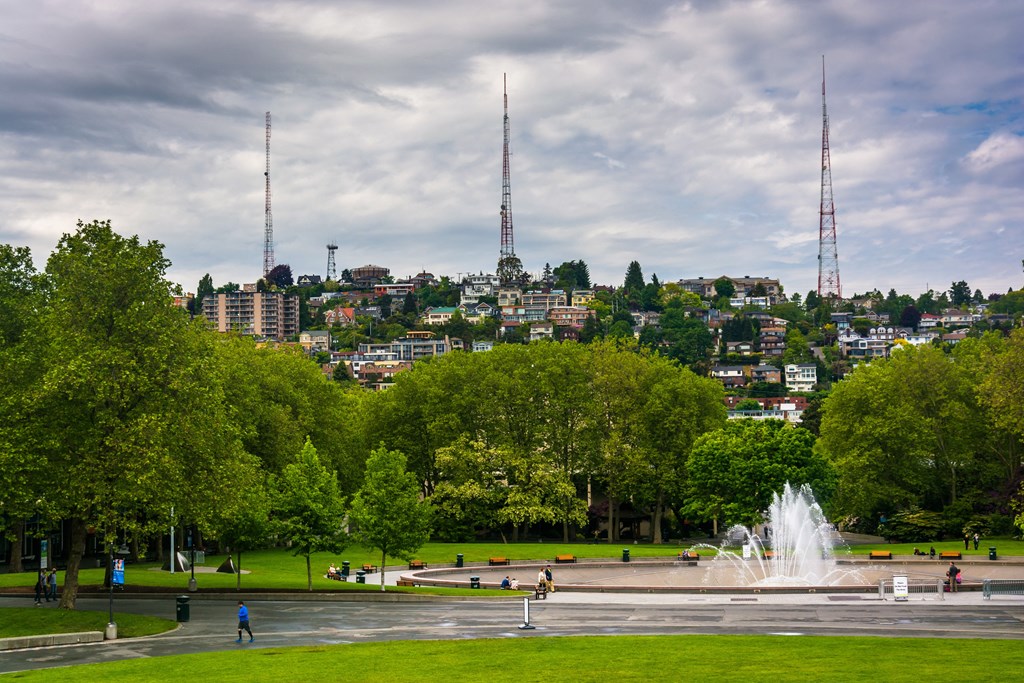 a fountain in the middle of a park with a city in the background  at Axis, Seattle, WA, 98109