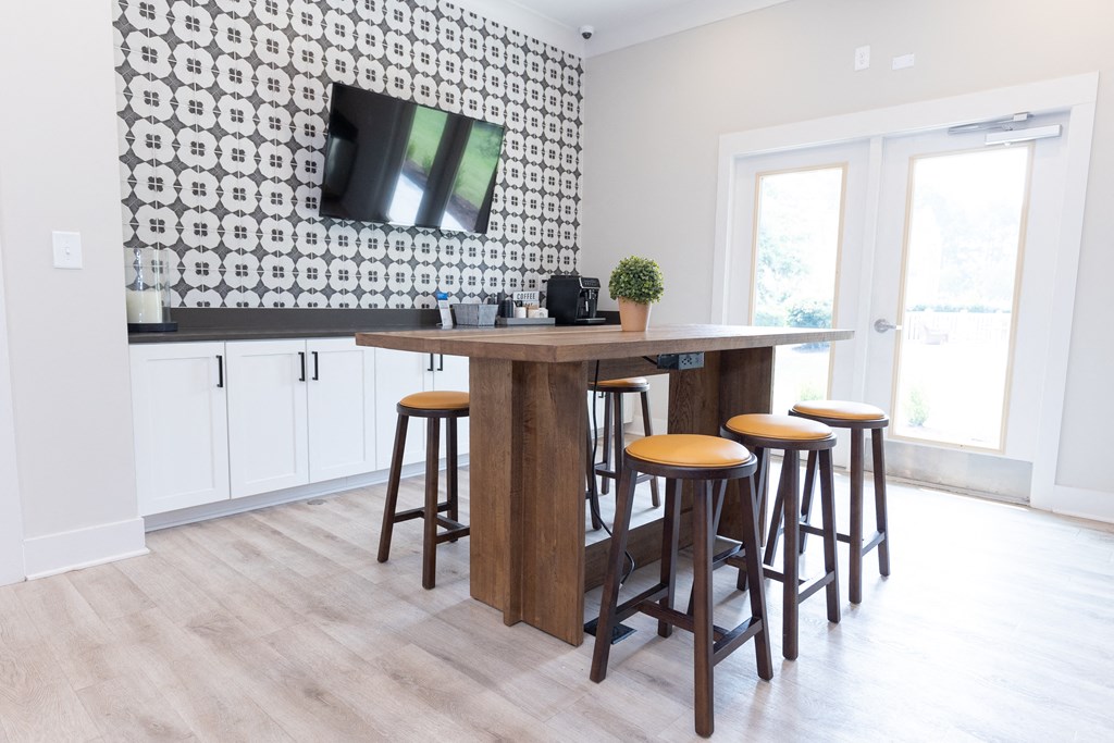Amenity Center with  table with four stools and a flat screen tv on the