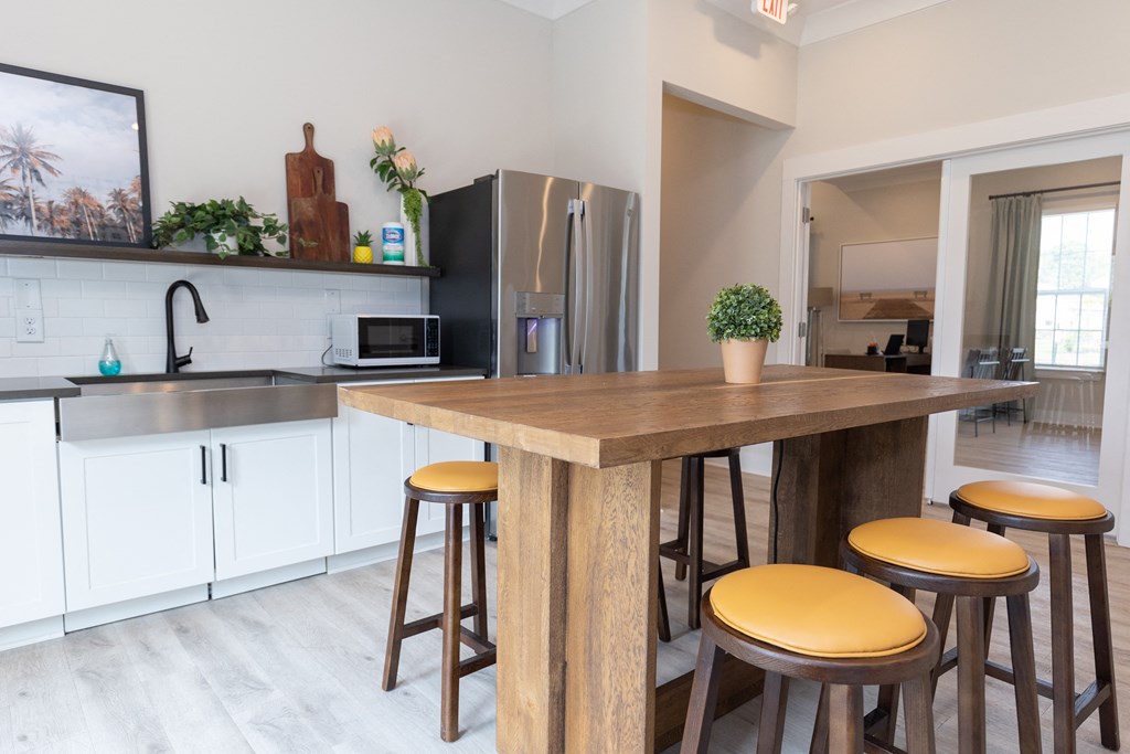 Amenity Center with  table with four stools and a flat screen tv on the