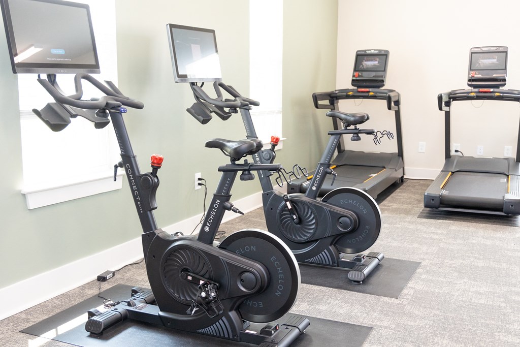 a row of exercise bikes in a gym