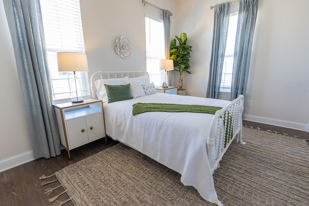 a bedroom with a white bed and green pillows