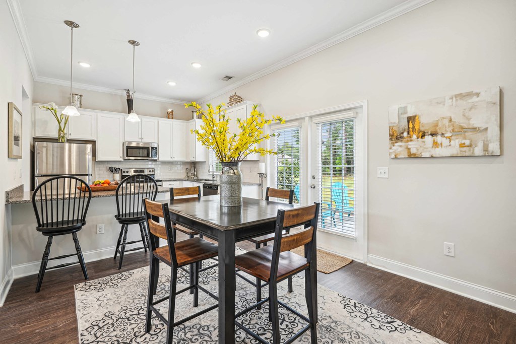 a dining room with a table and chairs and a kitchen