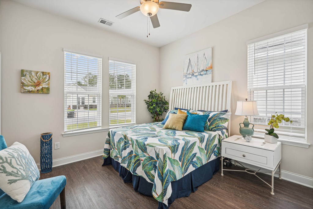 a bedroom with a bed and a ceiling fan