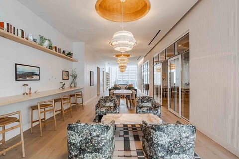 A modern living room with a long table and chairs.
