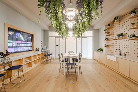A modern kitchen with a dining table and chairs.