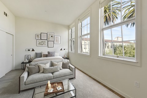 A living room with a grey couch and a coffee table.