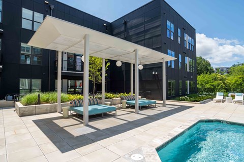 A modern outdoor pool area with a white canopy and a small pool.