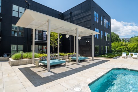 A modern outdoor pool area with a white canopy and a small pool.