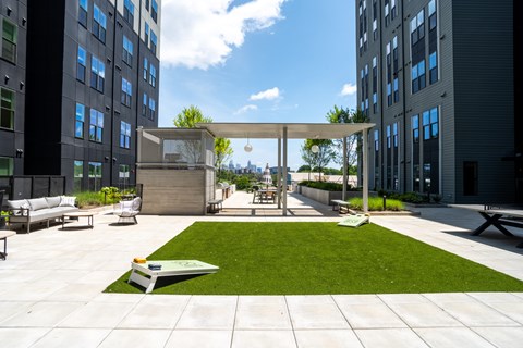 A grassy area in the middle of a courtyard surrounded by buildings.