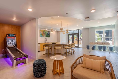 A room with a miniature bowling alley and a couch.