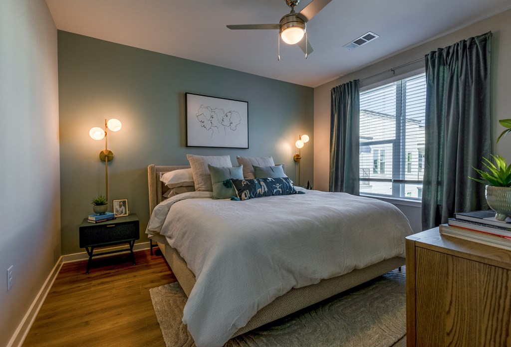 a bedroom with a large bed and a ceiling fan