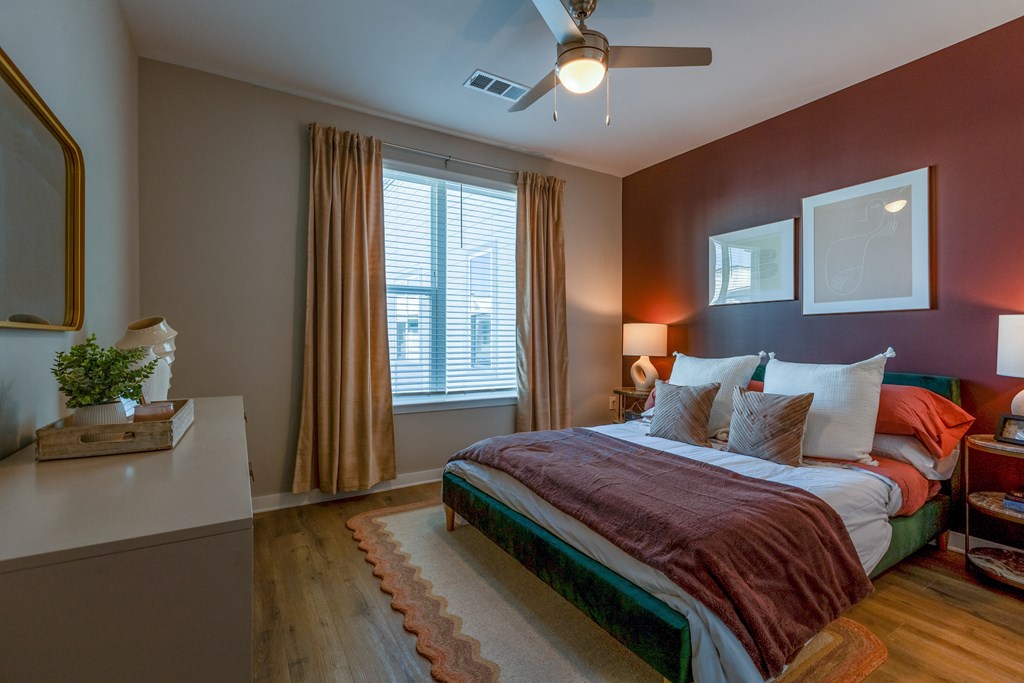 a bedroom with a bed and a ceiling fan