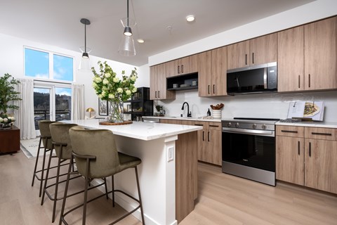 A modern kitchen with wooden cabinets and a white island.