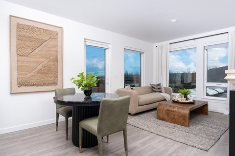 A living room with a dining table and chairs.