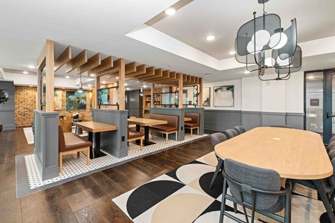 A modern dining area with a wooden table and chairs.