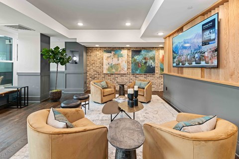 A modern living room with a large flat screen TV mounted on the wall.