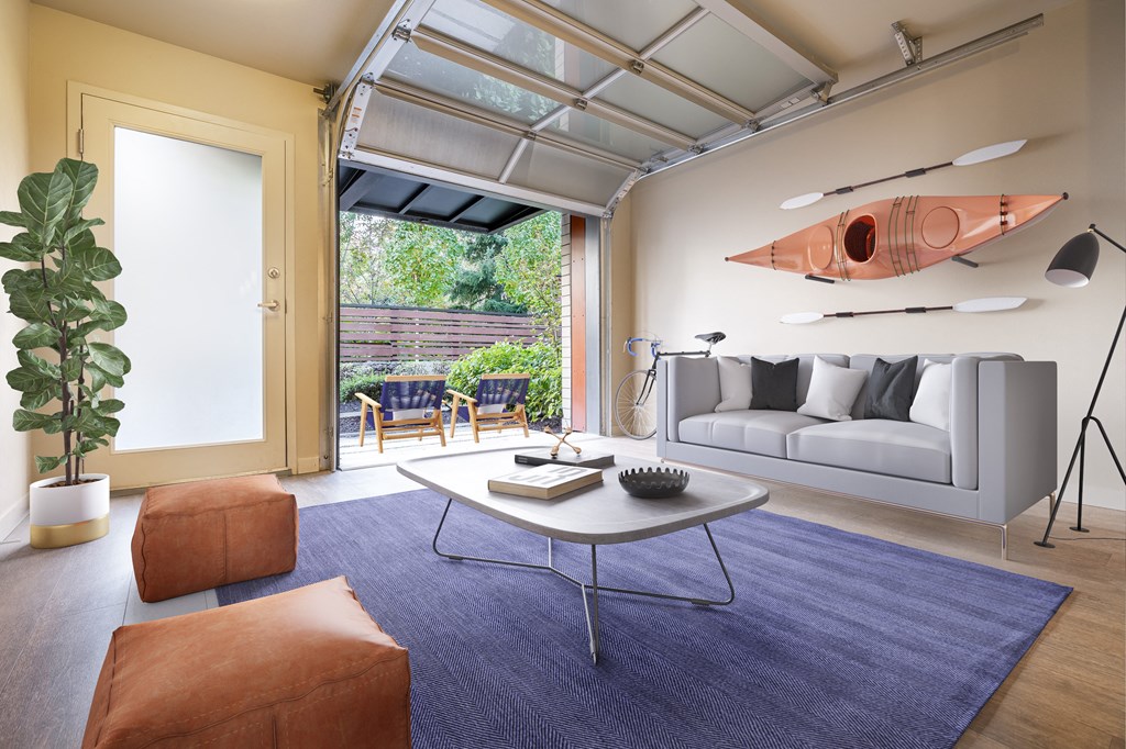 Staged Living room with open garage door at Allez, Redmond