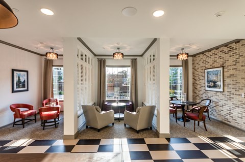 A room with a black and white checkered floor and a brick wall.